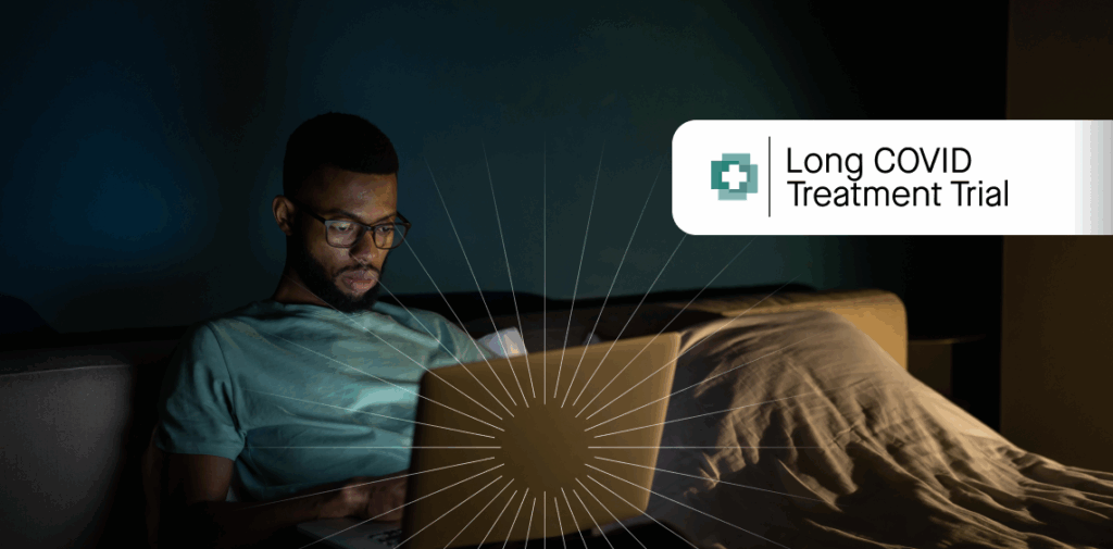 Man looking a a computer screen in bed