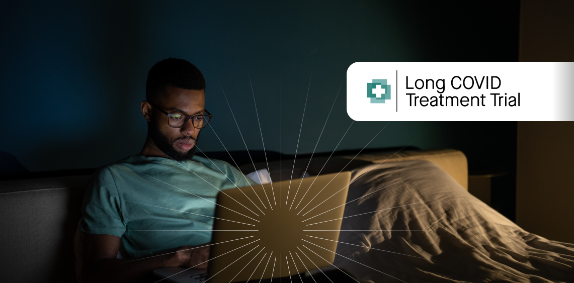 Man looking a a computer screen in bed
